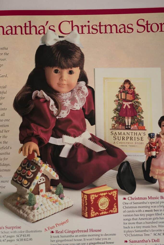 A photo of a Pleasant Company catalog with Samantha 18" doll in a red Christmas dress with white lace and ribbon trim.
