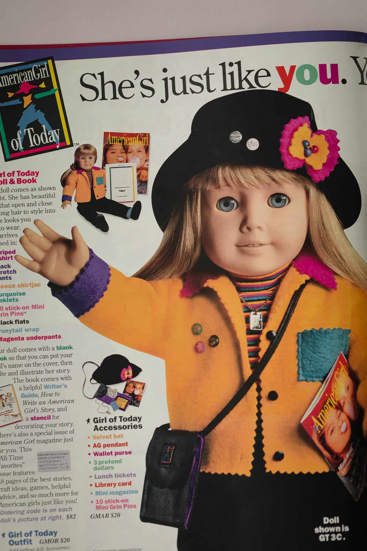 A page of a Pleasant Company catalog, "Girl of Today" with a doll in a yellow felt jacket.